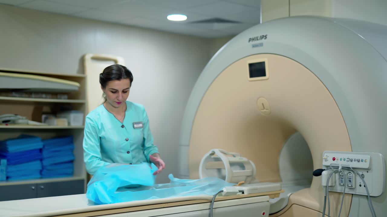 Nurse near magnetic resonance imaging diagnostic machine. Female doctor is standing by the modern MRI scanner in clinic. Computerized innovation tomography for medical tests.
