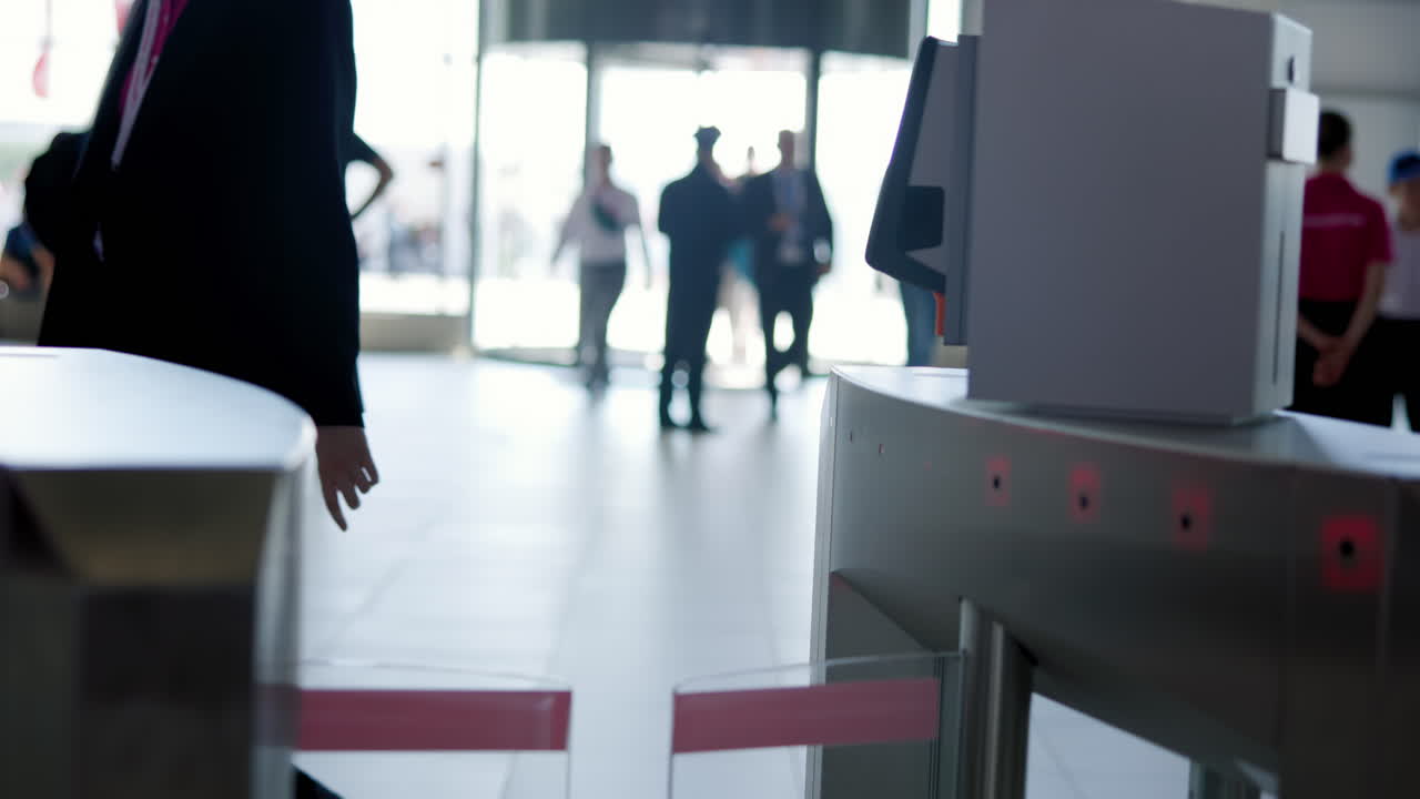 People interacting with and passing through turnstiles using smartphone technology