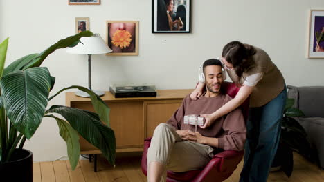 young man listening to music at home