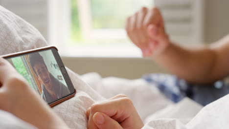 couple having a video call in bed