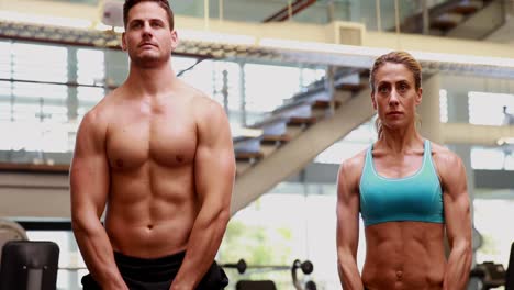 Two-fit-people-lifting-kettle-bells-together