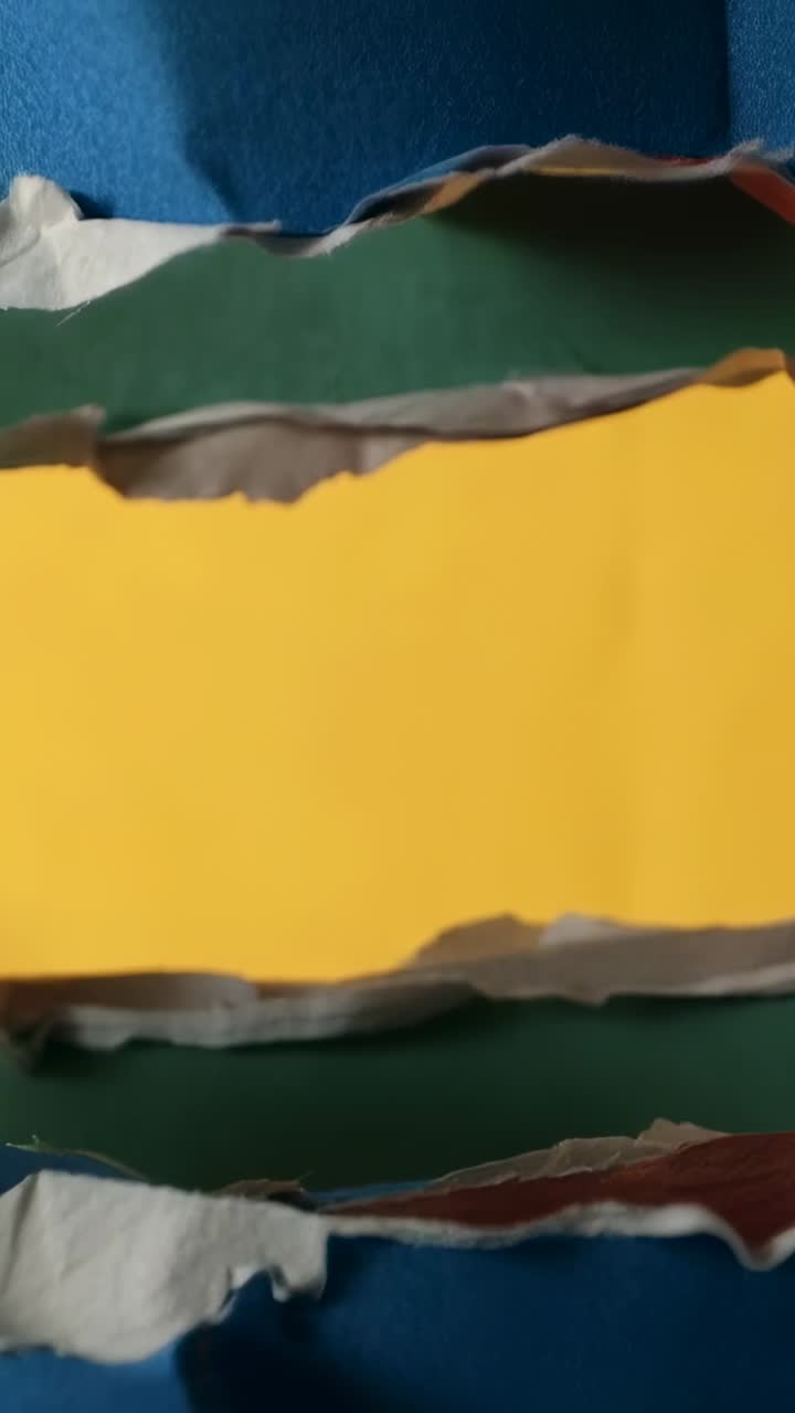 Vertical video: Zooming camera showing torn layers on green mat, emphasizing yellow layer and pin