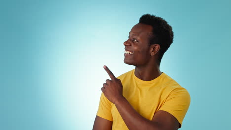 Man,-face-and-pointing-to-advertising-in-studio