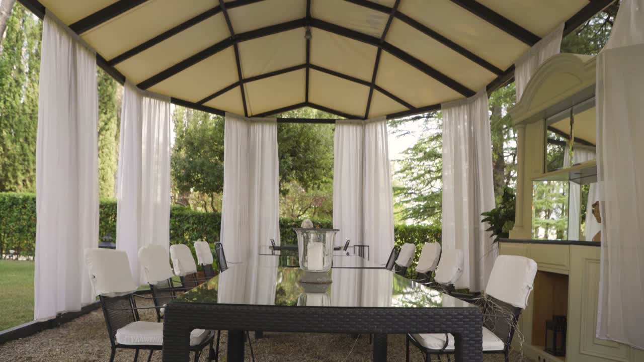 open gazebo structure with table and chairs for wedding party ceremony