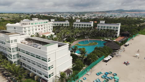 aerial view showing luxury beachside resort with private sandy beach and swimming pool in mui ne , vietnam