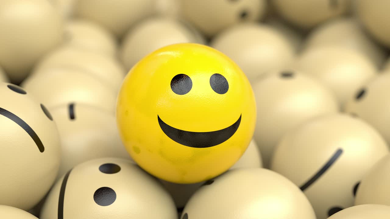 행복하고 낙관적인 공이 슬픈 공의 어리 위에 머리를 끄덕이고 웃고 있습니다.