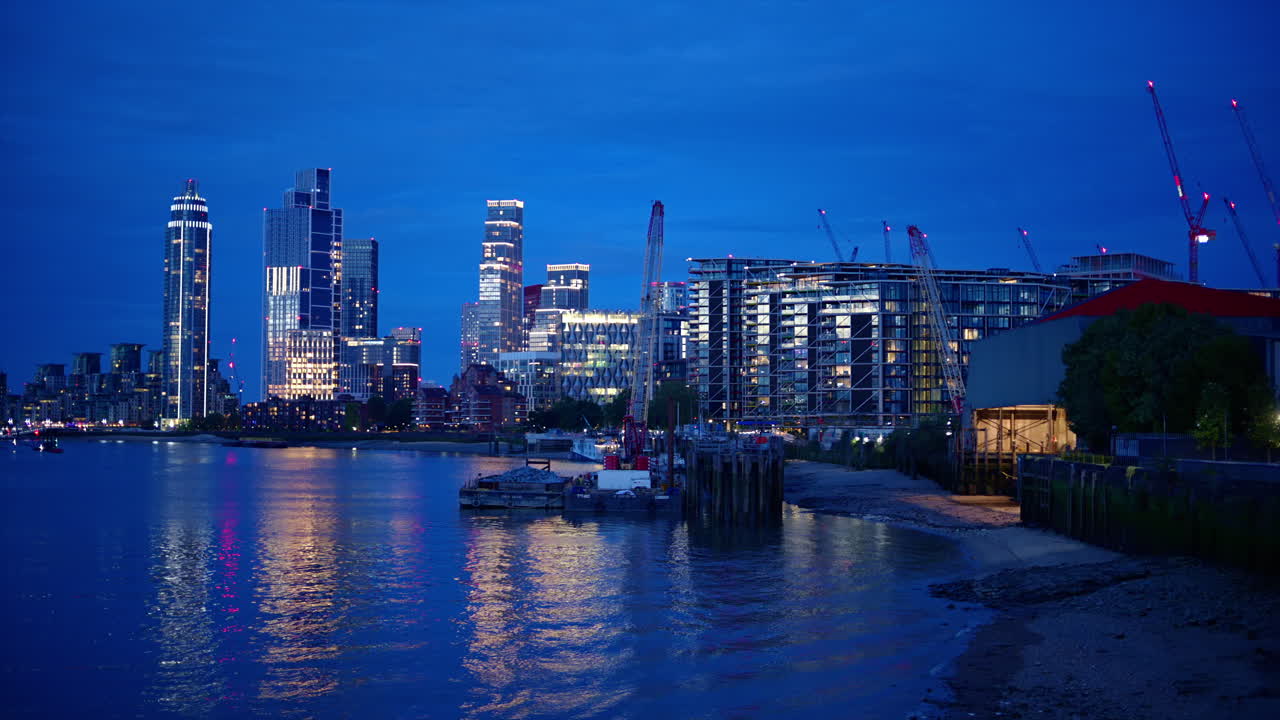 Cityscape of the London at evening, United Kingdom. Thames river and skyscrapers with illumination