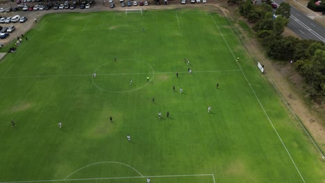 goalkeeper kick-off during amateur football match as seen from above