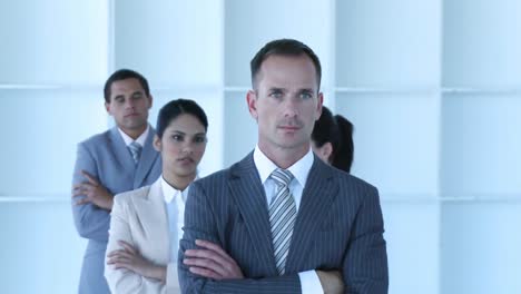 businessman leading his team with folded arms