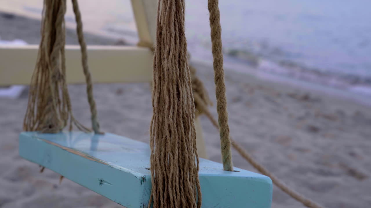 Rustic Wooden Swing on a Sandy Beach