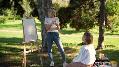 young girl learning painting outdoors