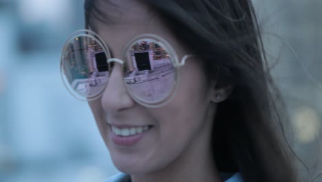 girl posing wearing with big round sunglasses at night in the evening