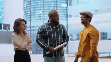 corporate client and agent reviewing office space blueprints