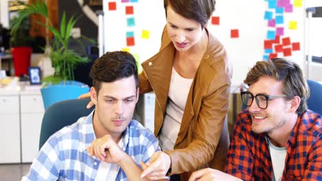 Executives-discussing-over-laptop