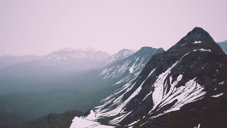 majestic mountain landscape with snow and misty atmosphere at dawn