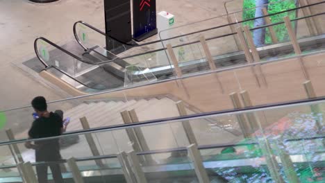 person descending an escalator in a spacious area