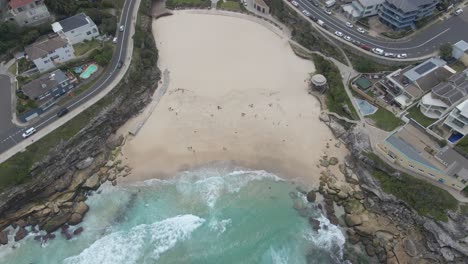 Bird's-Eye-View-Of-Tamarama-Beach-With-Few-People-On-Sandy-Shore-In-Eastern-Suburbs-Sydney,-New-South-Wales,-Australia