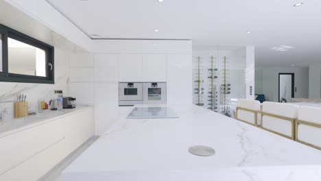 Tracking-shot-of-elegant-interiors-of-kitchen-and-eating-table-in-villa