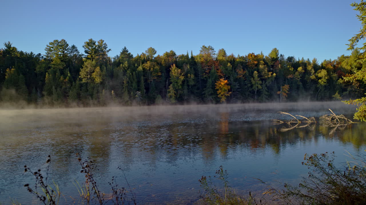 Cinematic atmospheric river shot of fog lifting at sunrise