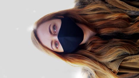 Woman-Wearing-Reusable-Protective-Mask-in-Winter.health,-safety-and-pandemic-concept-–-young-woman-wearing-black-face-protective-reusable-barrier-mask-outdoors-over-snow-in-winter