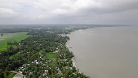 Riverside-Village-with-Rural-Agricultural-Farmland-Fields-Aerial-View