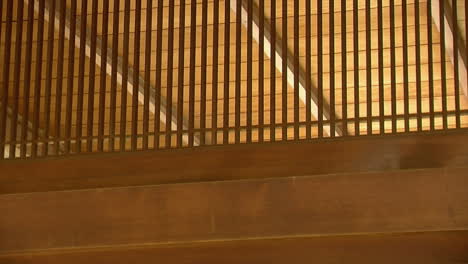 pan left-to-right across hinoki wood latticework in a japanese house