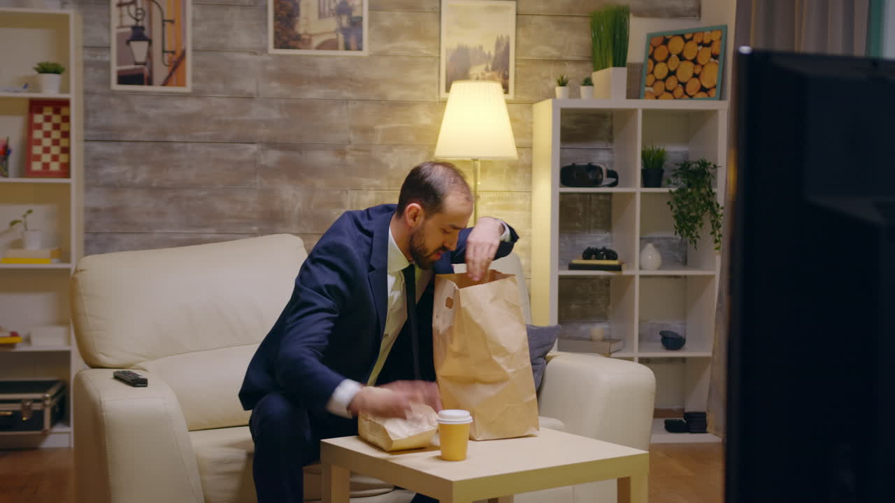 Hungry businessman in suit arriving home