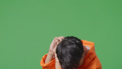 handcuffed prisoner on green screen