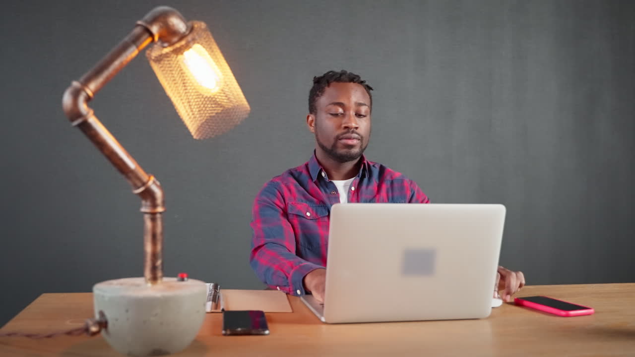 Man Working on Laptop in Home Office