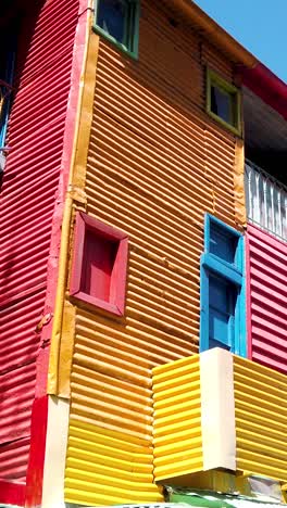 vertical at colorful ghetto houses of la boca, caminito, buenos aires argentina tango neighborhood