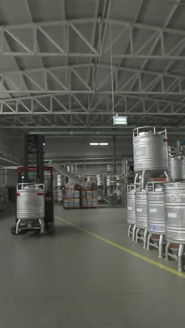 forklift carries the metal barrels