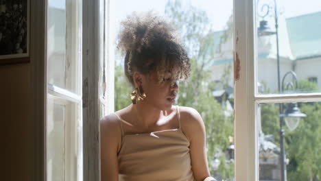 close-up view of fashionable african woman drinking lemonade and reading a book