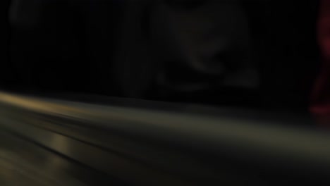 close up of hands of crowd holding a black handrail at public transport escalator