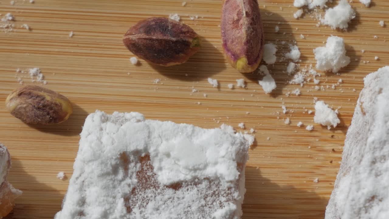 Cyprus delight with sugar coating and pistachios on a wooden background