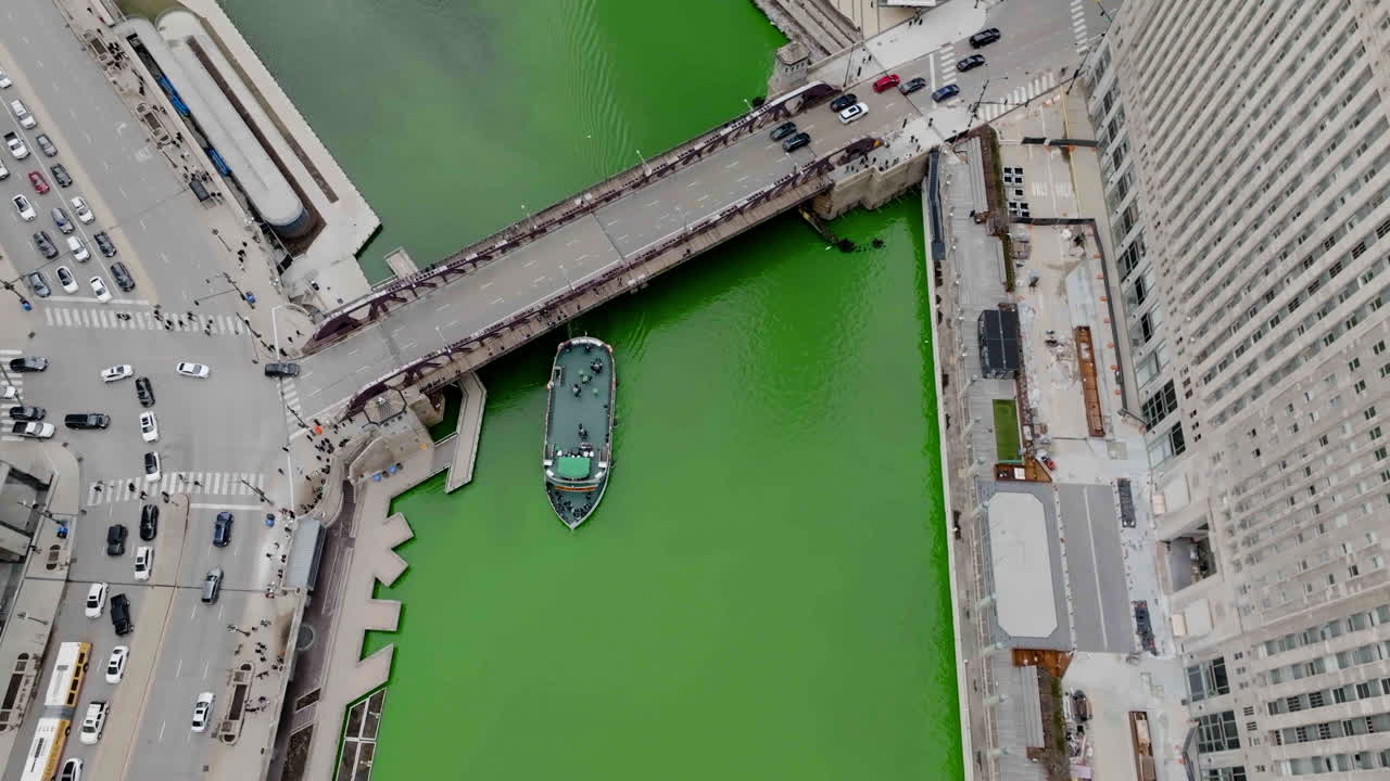 Aerial tilt shot of boats and traffic on the river,in downtown Chicago, on St Patrick&acute;s day