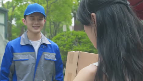 delivery man uniform smiles during express, courier holding a small package parcel delivering goods to customer's home with van truck, door-to-door services