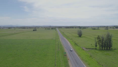 Driving-On-Asphalt-Road-Through-Lush-Green-Fields-In-Kempsey,-New-South-Wales,-Australia