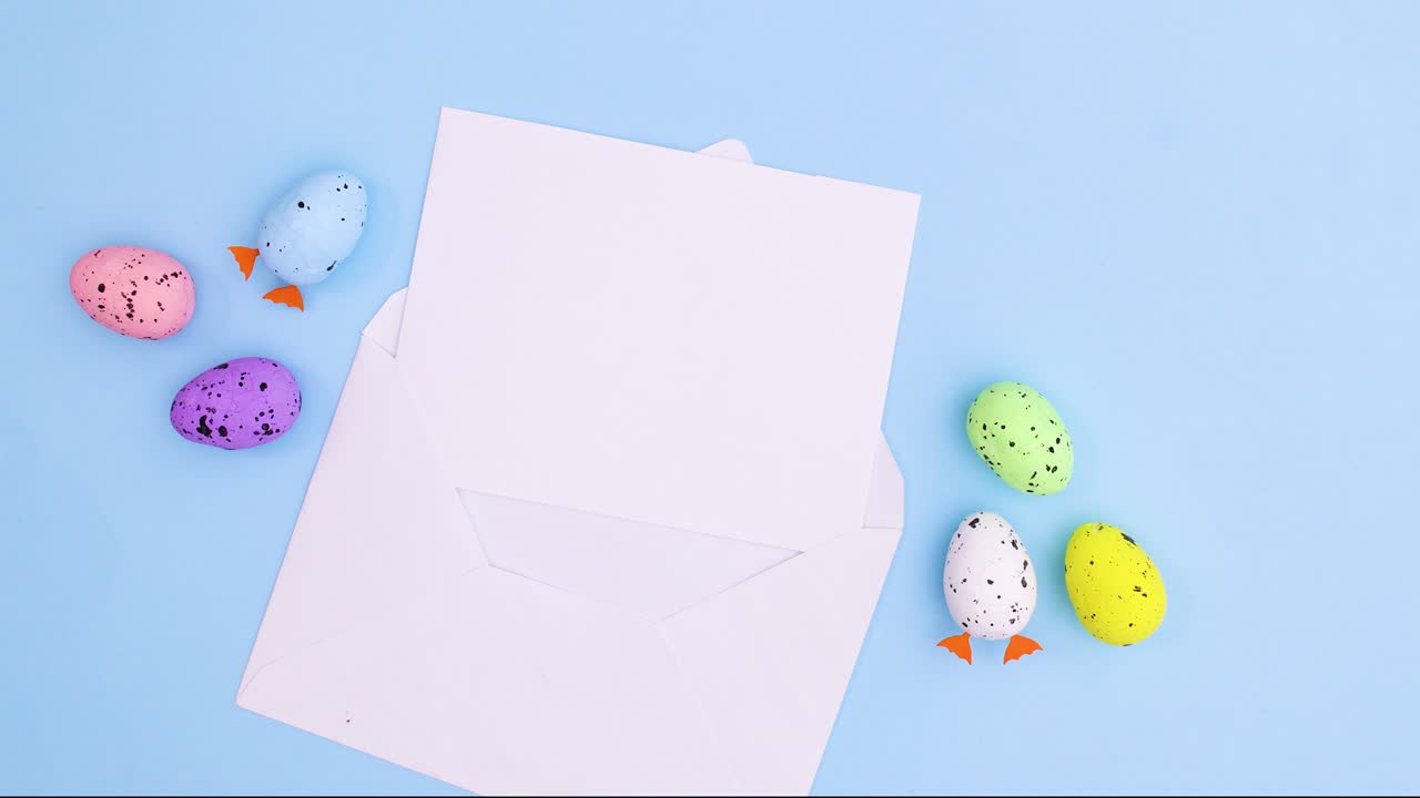 Paper in envelope for text and eggs for Easter on pastel blue theme.Stop motion