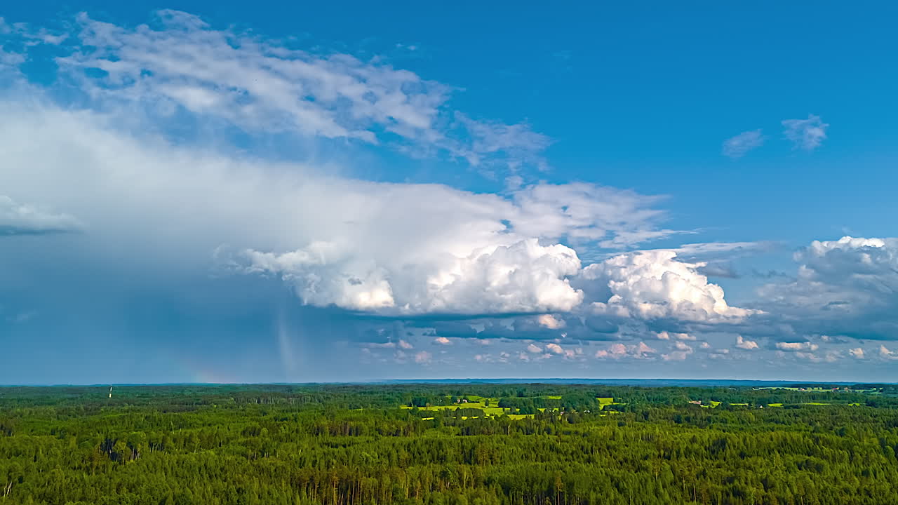 Cumulonimbus cloud thundercloud with rain falling from its base timelapse forest nature