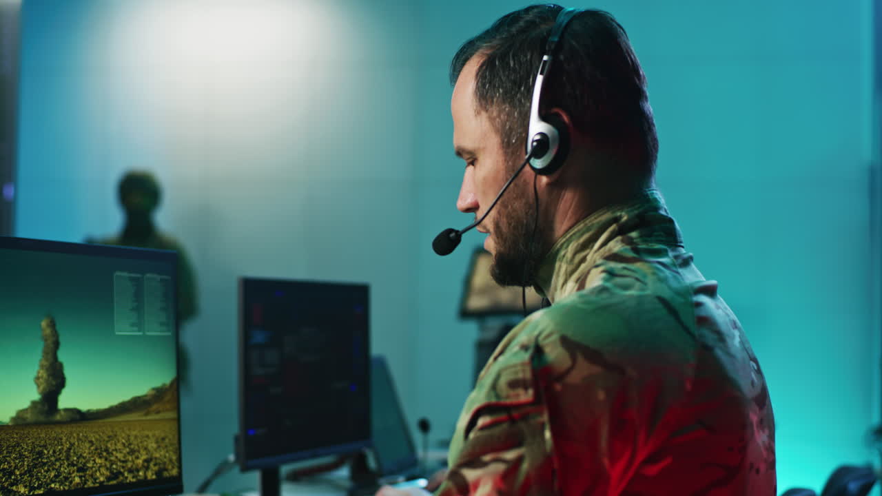 Military personnel in a control room monitoring satellite imagery