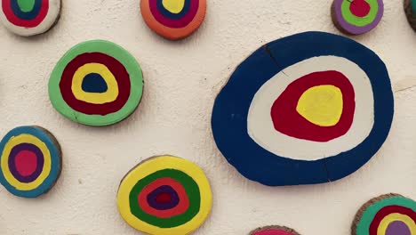 footage of painted woods in evil eye concept used as wall decorations in famous, touristic aegean town called "sigacik".