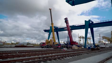 industrial cranes and heavy equipment at a port or construction site