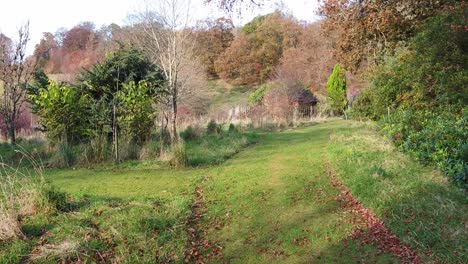 Walk-through-a-scottish-country-home-garden-with-a-loch-and-mountain-scenery