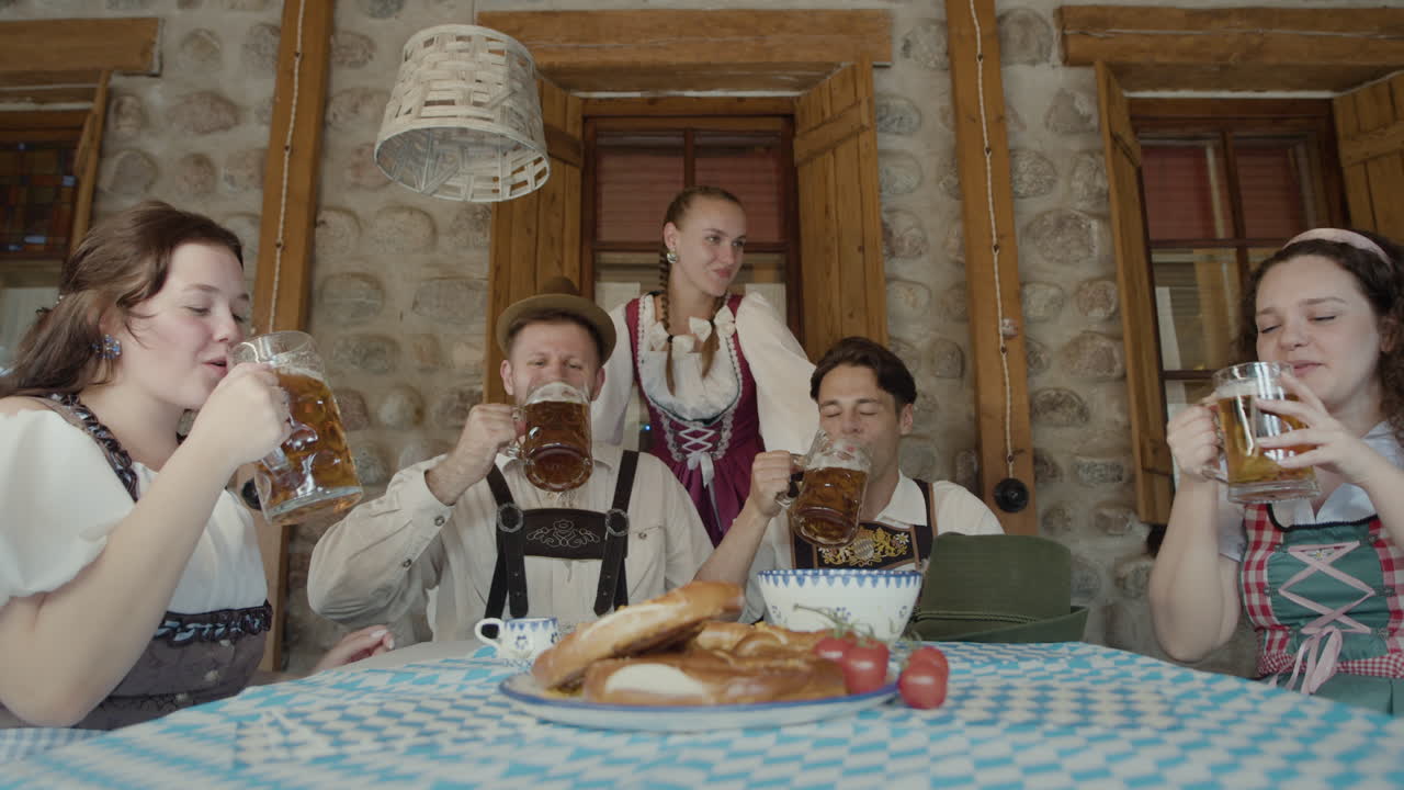 People celebrating Oktoberfest with beer and traditional Bavarian food