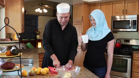 middle eastern modern couple in kitchen he chops ws track right