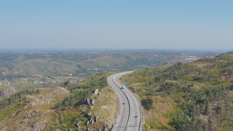 panoramic view of a freeway cutting nature