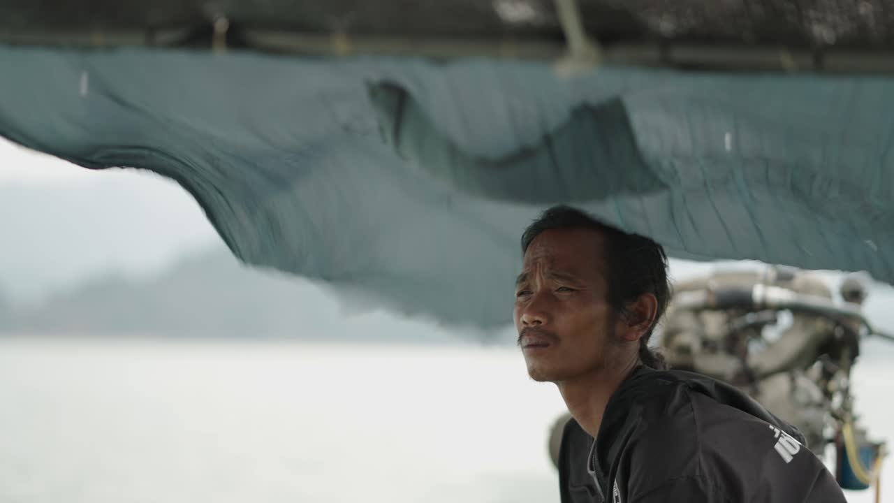 A man on a boat on the water