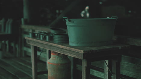 vintage wooden table with metal bucket and utensils