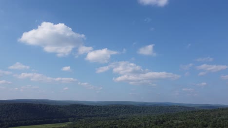 time-lapse of a cloudy sky over a forest full of trees