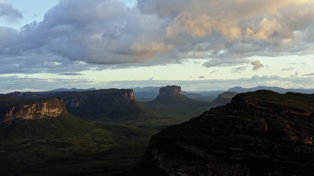 Tilting up flying drone landscape shot of the stunning Capao Valley from the Mount of Pai Inácio in the Chapada Diamantina national park in northern Brazil on a warm sunny summer evening